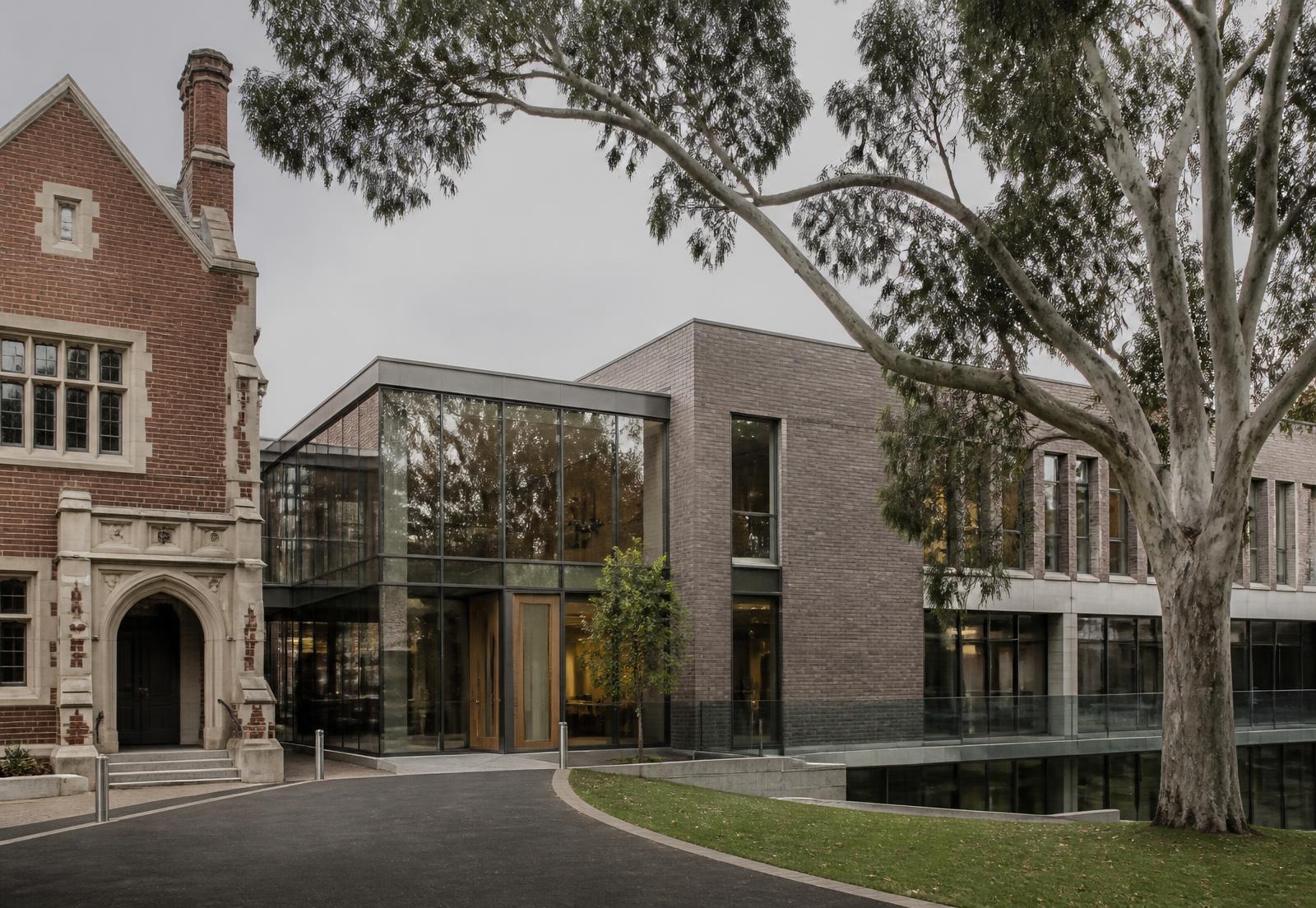 Heritage and contemporary school buildings around a landscaped courtyard